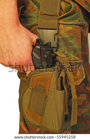 Uniformed soldier draws his gun from the holster - it is war
