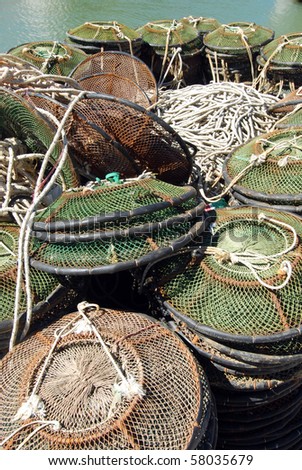 A pile of Lobster pots and fishing net on the dock ready to be loaded on the fishing boat
