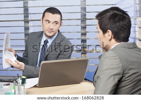 Manager reviewing workers job performance