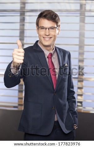 Young handsome businessmen showing thumb-up in the office