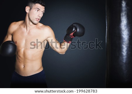 Boxer training on a punching bag in the gym