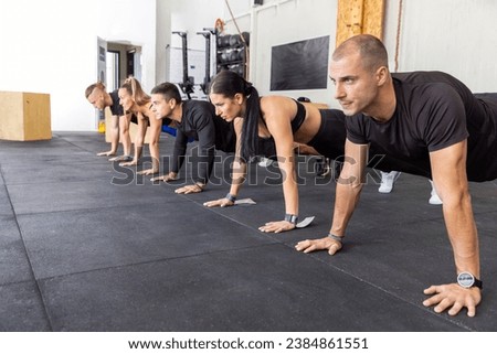 Similar – Image, Stock Photo Female athlete doing push-ups outdoors