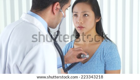 Mexican doctor listening to patient\'s heart