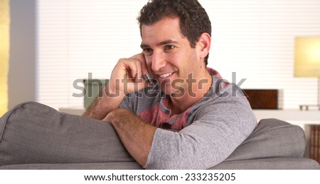 Man talking on smartphone in living room