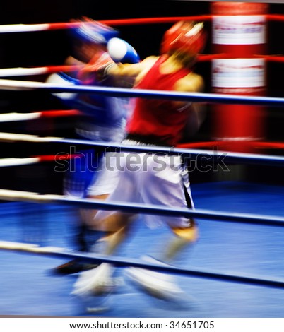 Two boxers fighting at the ring