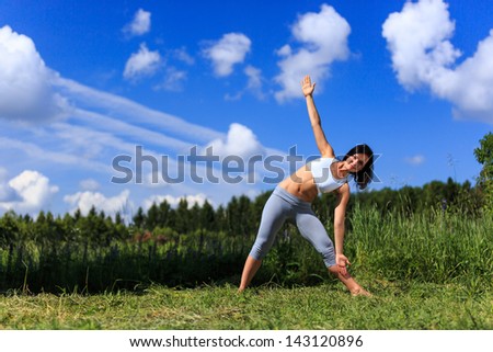 girl doing yoga outdoor looking in camera, ladscape