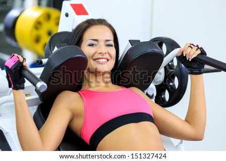 young women do a workout at the gym looking in camera and smiling