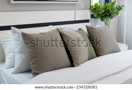 modern bedroom with brown and green pillow on bed