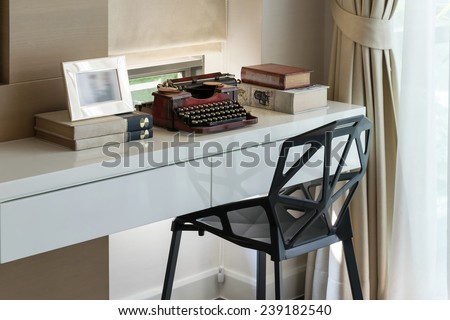decorative working table with typewriter and books