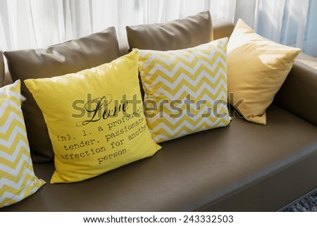 modern living room design with brown sofa and yellow pillows