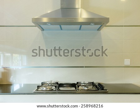cooking gas stove with hood in modern kitchen