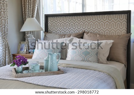 wood tray of tea cup set on bed in bedroom interior