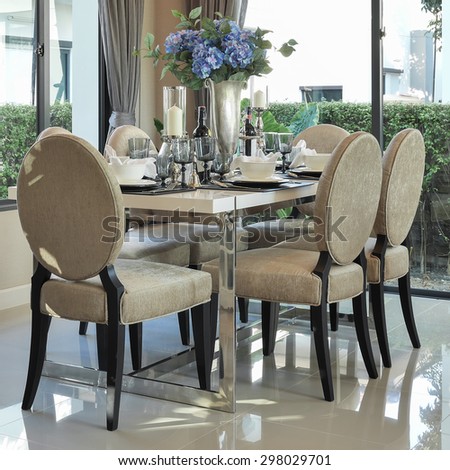 modern dining table and comfortable chairs with elegant table setting