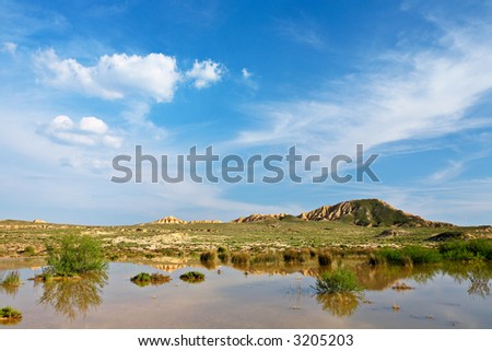 Hill over the blue sky and the lake in season spring