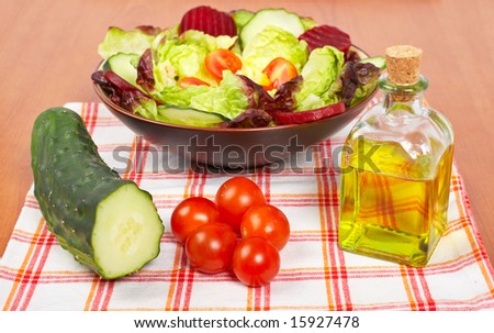 Mediterranean salad with lettuce tomatoes cucumber oil and beet. Shallow depth of field