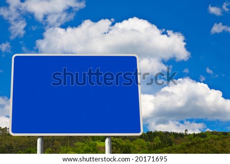 Blank billboard on blue sky in a mountainous area, just add your text