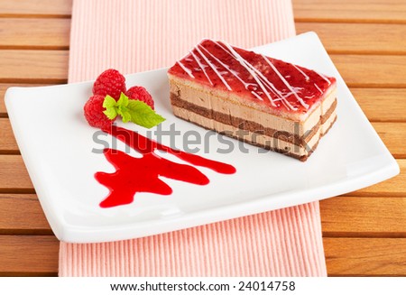 Delicious strawberry cake with soft shadow on white dish. Shallow depth of field