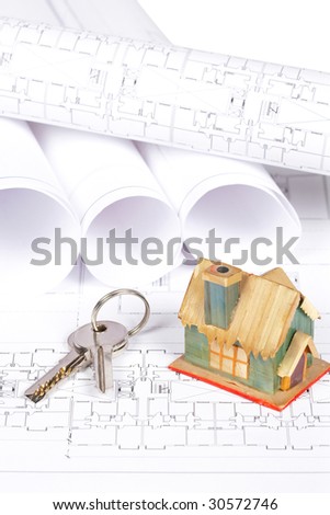 Construction plans, keys and house. Very shallow depth of field