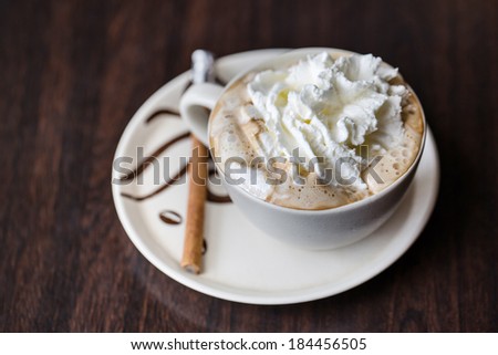 Cup of whipped cream Vienna coffee with cinnamon stick