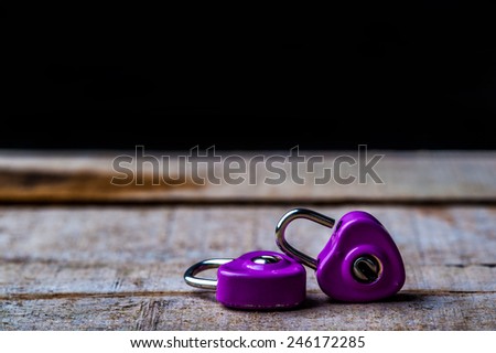 purple padlock  on wood  background