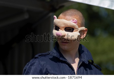 artist wearing pig mask