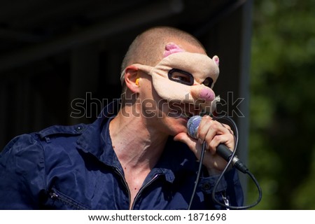 artist wearing pig mask