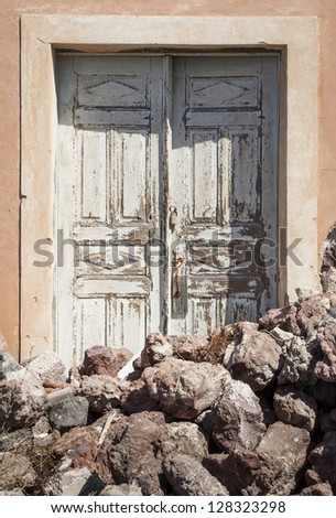 Door with lava rocks in front of it, Santorini,  South Aegean, Greece