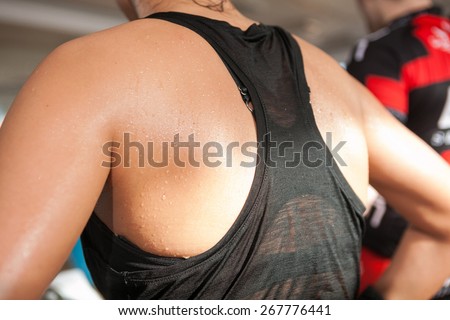 detail gym shot - sweat skin of a woman\'s back; spinning, aerobic class