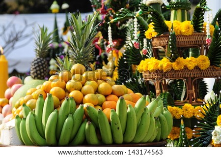 Set of fresh tropical fruits: banana, orange, pineapple and Set of fold leaves and marigold in ritual ceremony