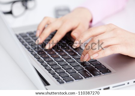 Closeup portrait of woman\'s hand typing on computer keyboard