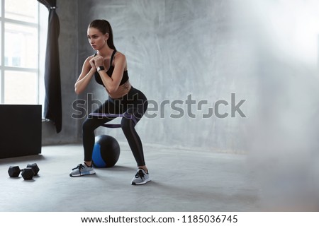 Similar – Image, Stock Photo Woman with resistance band on wrists working out at home