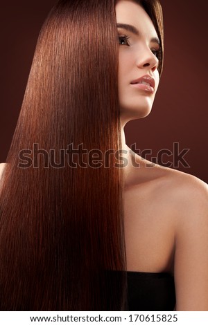 Brown Hair. Portrait of Beautiful Woman with Long Hair. High quality image.