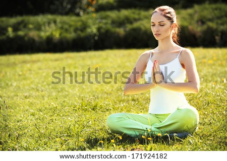 Young and beautiful woman doing yoga exercises .Yoga background