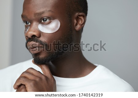 Black man with makeup covering face