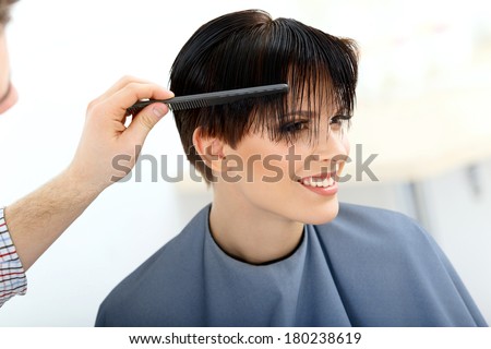 Brunette with Short Hair in Hair Salon. Hairdresser doing Hairstyle. Haircut. Hair care