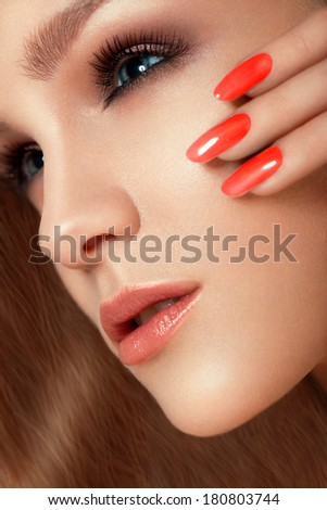 Manicure and Make-up. Beautiful Woman With Red Nails and Luxury Makeup. Beautiful Girl Face