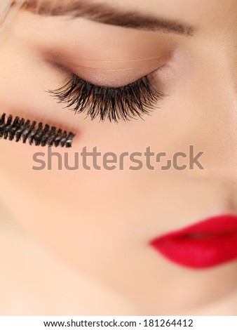 Woman eye with beautiful makeup and long eyelashes. Mascara Brush. High quality image.