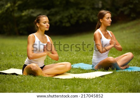 Yoga class. Woman exercising in summer park