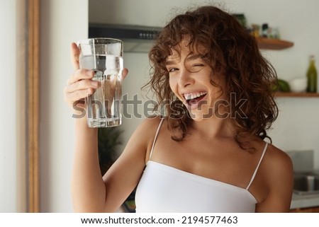 Similar – Image, Stock Photo Young woman drinking water while training on mat at home