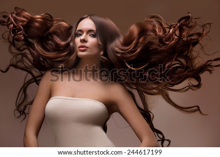 Hair. Portrait of Beautiful Woman with Long flying Hair. High quality image.