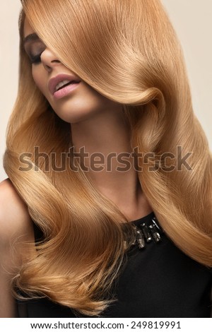 Blond hair. Portrait of beautiful Blonde with Long Wavy Hair. High quality image.