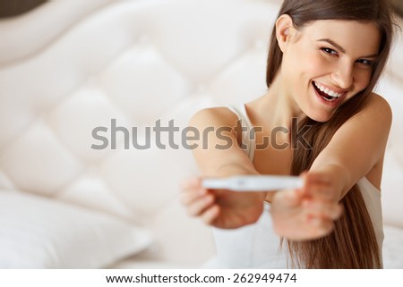 Happy Woman With Pregnancy Test