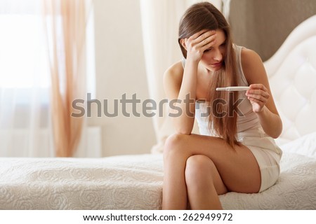 Worried Woman Looking at a Pregnancy Test