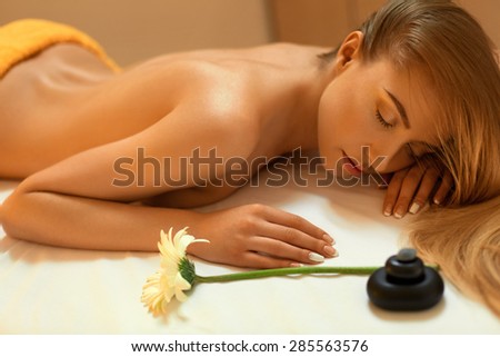 Spa Woman. Blonde Getting Recreation Massage in Spa Salon. Wellness Concept