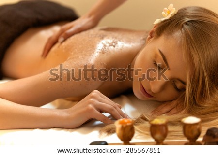 Body Scrub. Beautiful Blonde Gets a Salt Scrub Beauty Treatment in the spa Salon