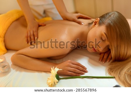 Spa Woman. Blonde Getting Recreation Massage in Spa Salon. Wellness and spa concept