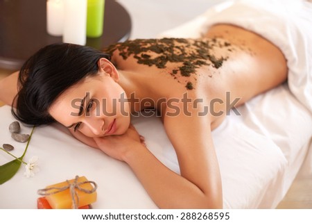 Woman Gets a Marine Algae Wrap Treatment in Spa Salon