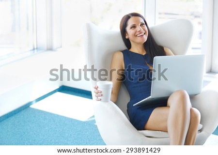 Portrait of relaxed business woman in office. Relax and freedom concept