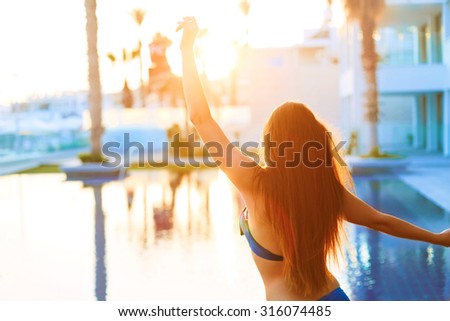 Dance of freedom and passion. Attractive girl with long beautiful hair enjoying summer.