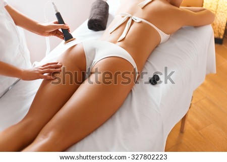 Body care. Spa treatment. Ultrasound cavitation body contouring treatment. Woman getting anti-cellulite and anti-fat therapy in beauty salon.